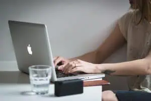 woman undertaking keyword research on laptop at table